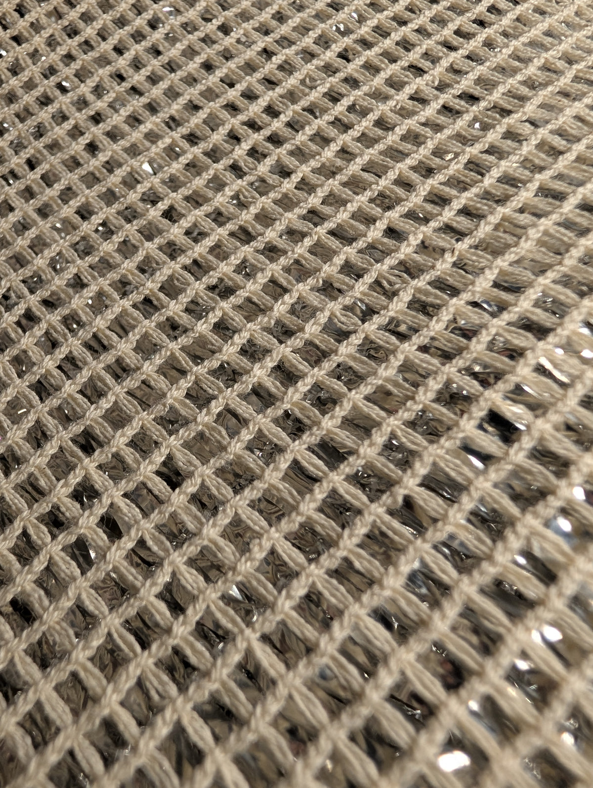 Close-up of Chillybuddy's woven cotton mesh fabric in a light beige color, showing the detailed texture of the threads.